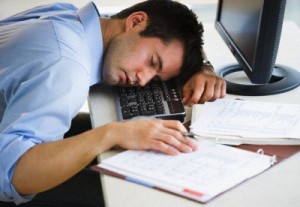 Businessman asleep at his desk --- Image by © Tetra Images/Tetra Images/Corbis